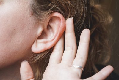 Close up of a woman ear and hair  in a conceptual image about hearing and communication